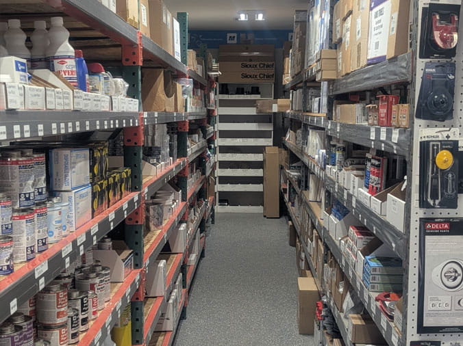 PLumbing supplies on stocked shelves at Bud's Plumbing